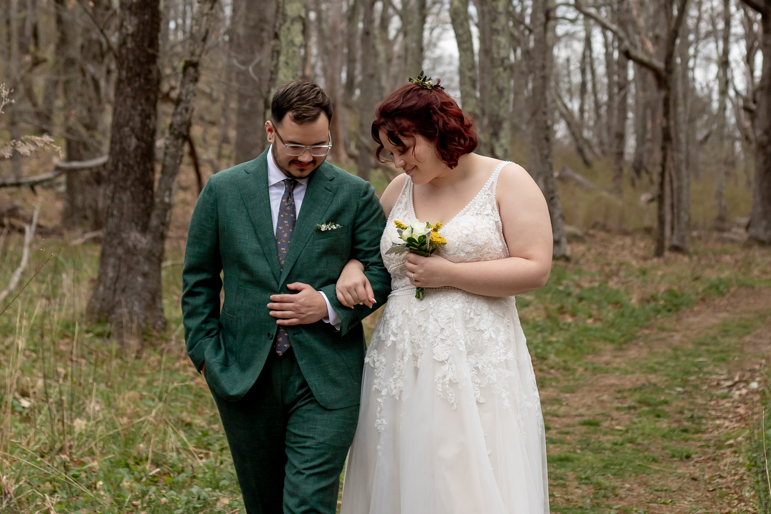 Couple walking arm in arm through the early spring forest in Shenandoah National Park